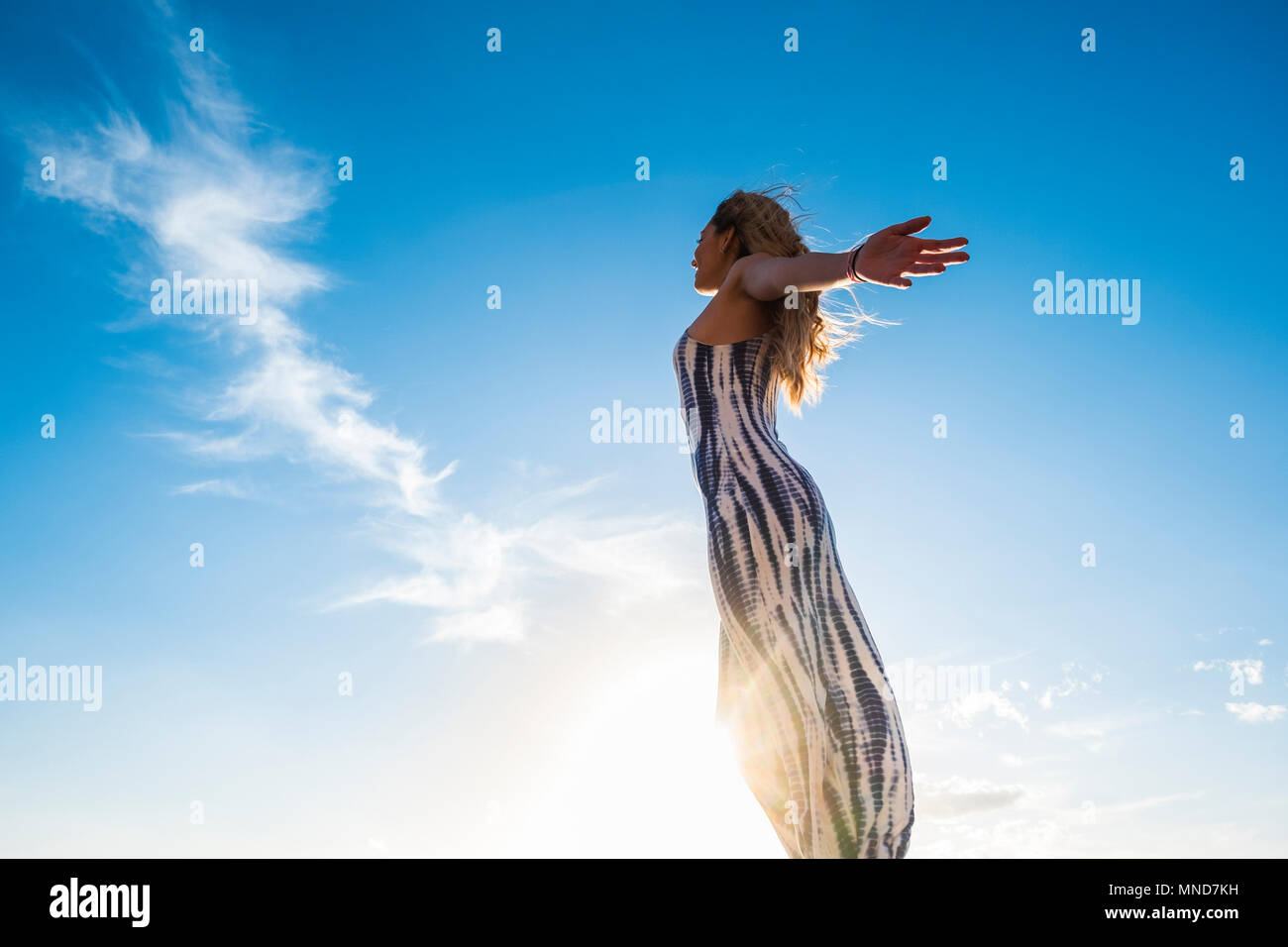 Young nice woman enjoy her freedom opening arms. Independent life and great feel with the world. Embrace all with satisfaction. Tenerife soul. Stock Photo