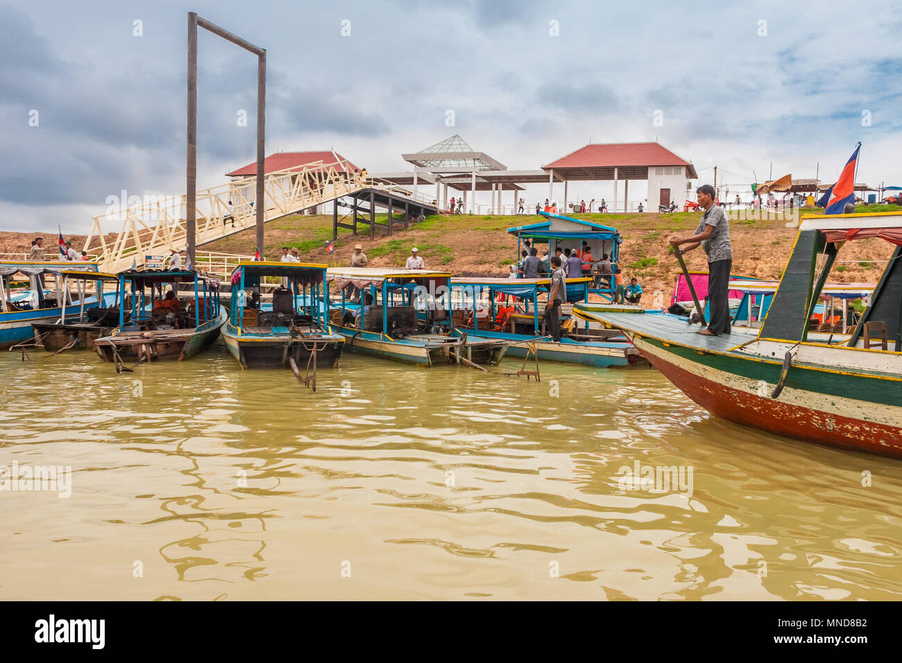 A lot of boatsmen waiting in the port at the Siem Reap river which is the starting point of the boat ride to the floating village Chong Kneas. Stock Photo