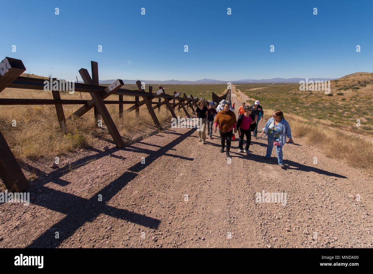 Americans are walking along the US and Mexican border in Douglasville, Arizona. On the other side is Agua Prieta, Mexico. Stock Photo