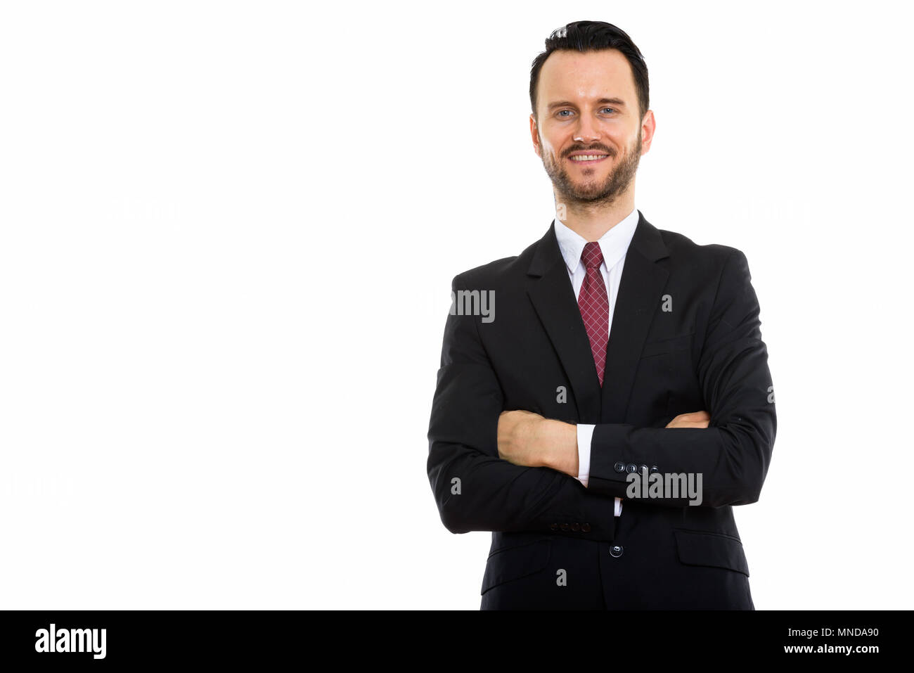 Studio shot of young happy businessman smiling with arms crossed Stock ...