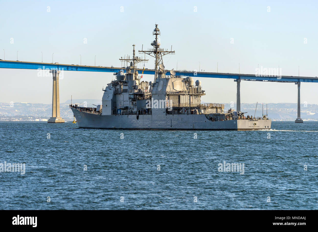 USS Princeton at San Diego Bay - The guided-missile cruiser is sailing towards Coronado Bridge at its homeport of Naval Base in San Diego Bay, CA, USA Stock Photo