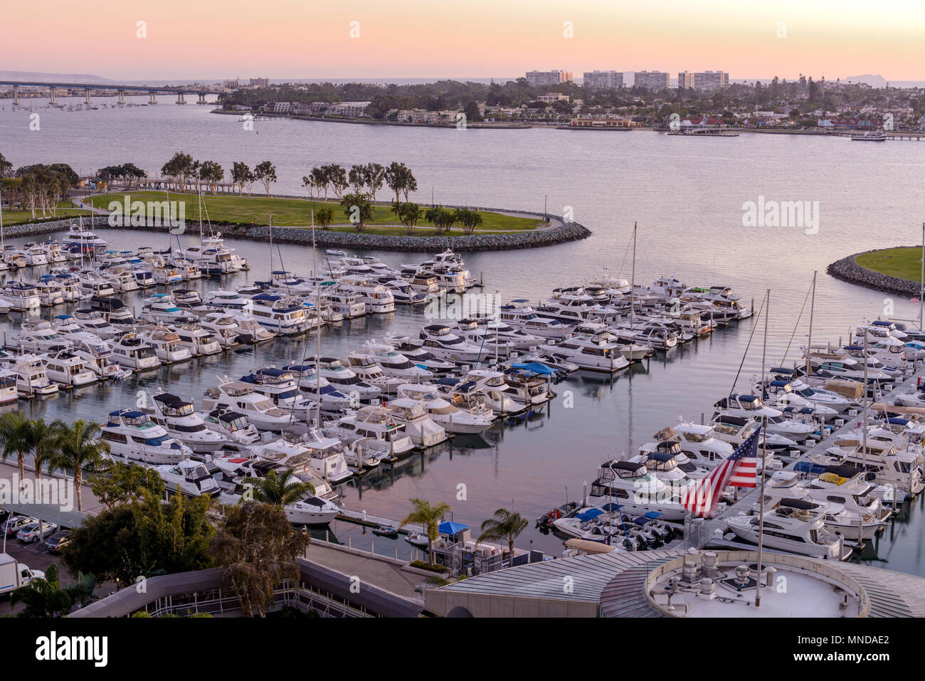 Sunset San Diego Bay - An aerial sunset view of San Diego Bay and San Diego Marina, with Coronado Bridge and Coronado Peninsula in background. CA, USA Stock Photo