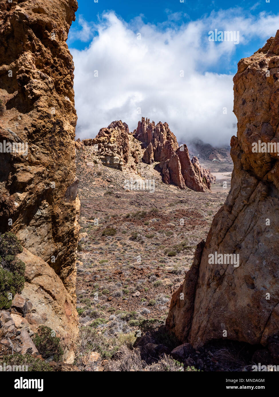 Pinnacles of the Roques de Garcia in the Las Canadas caldera of Mount Teide on Tenerife Canary Islands seen through a cleft in breccia cliffs Stock Photo