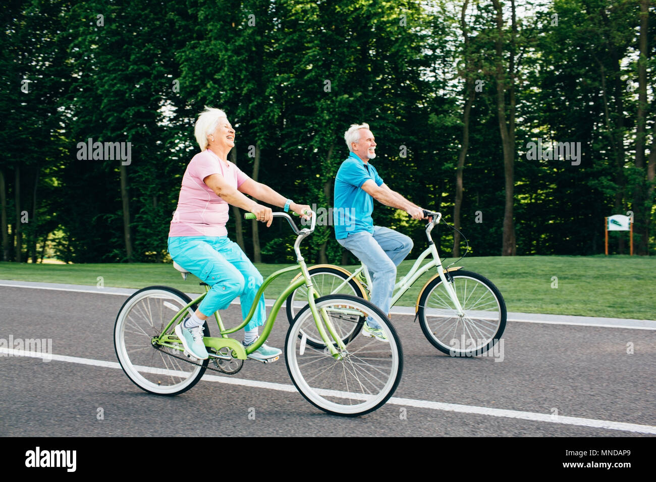 Older Caucasian couple riding bicycle Stock Photo