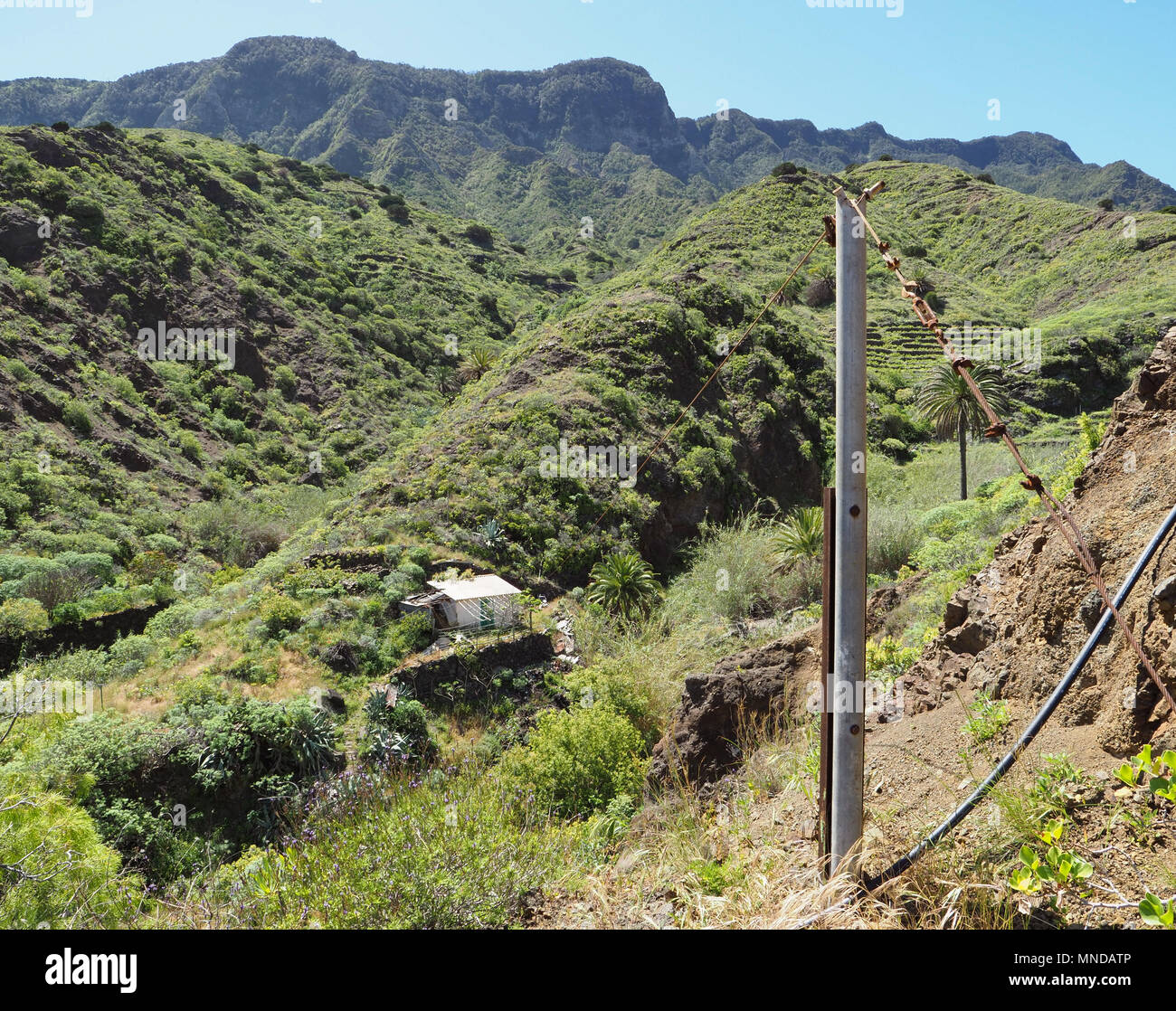 Remote house with flying fox pulley to transport goods down the steep barranco near Hermigua in the north of La Gomera in the Canary Islands Stock Photo
