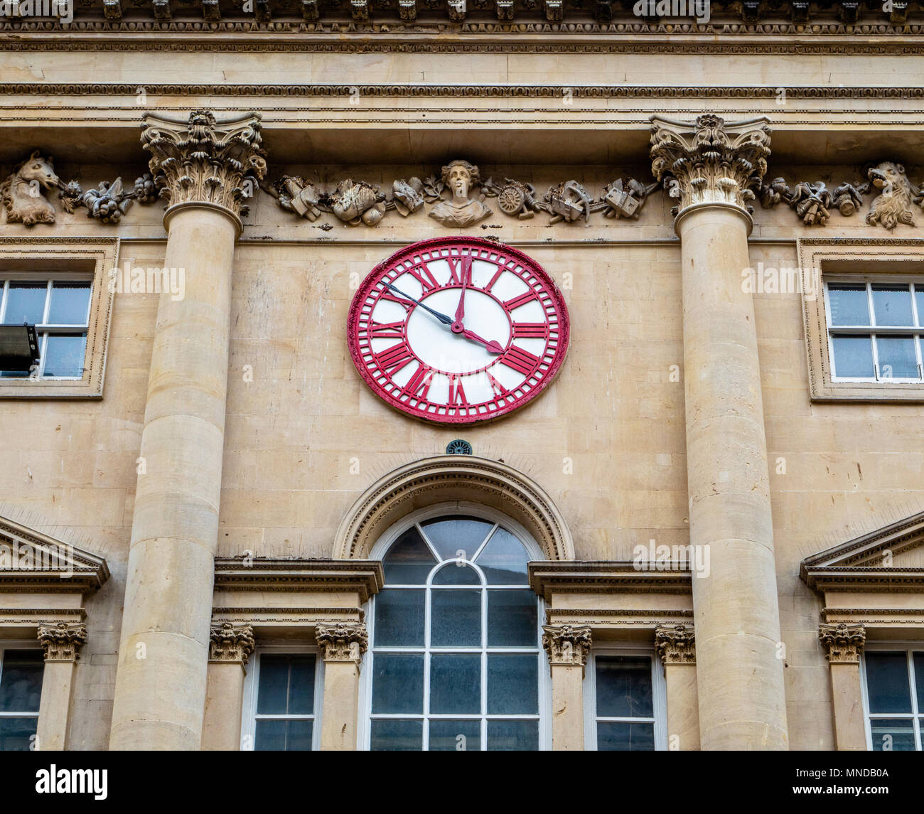 Clock on the face of the Corn Exchange building Bristol which has two minute hands - one showing GMT and the other old Bristol time ten minutes later Stock Photo