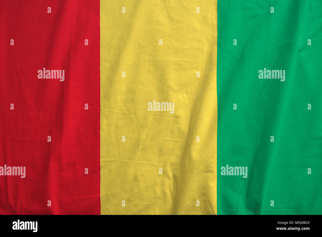 Fabric texture of the flag of Guinea Stock Photo