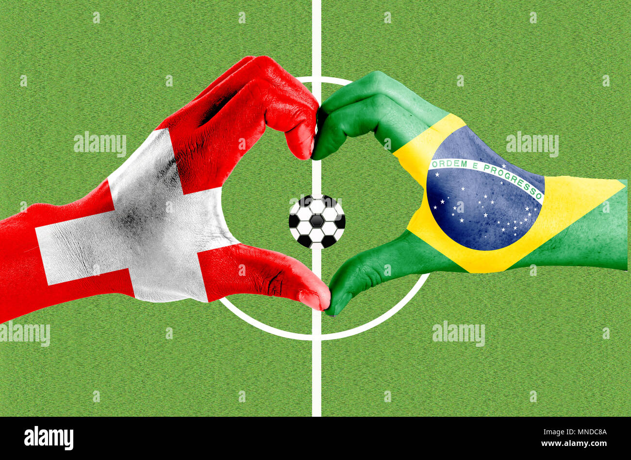 Hands painted in national flag forms love, Football game between Brazil and Switzerland Stock Photo