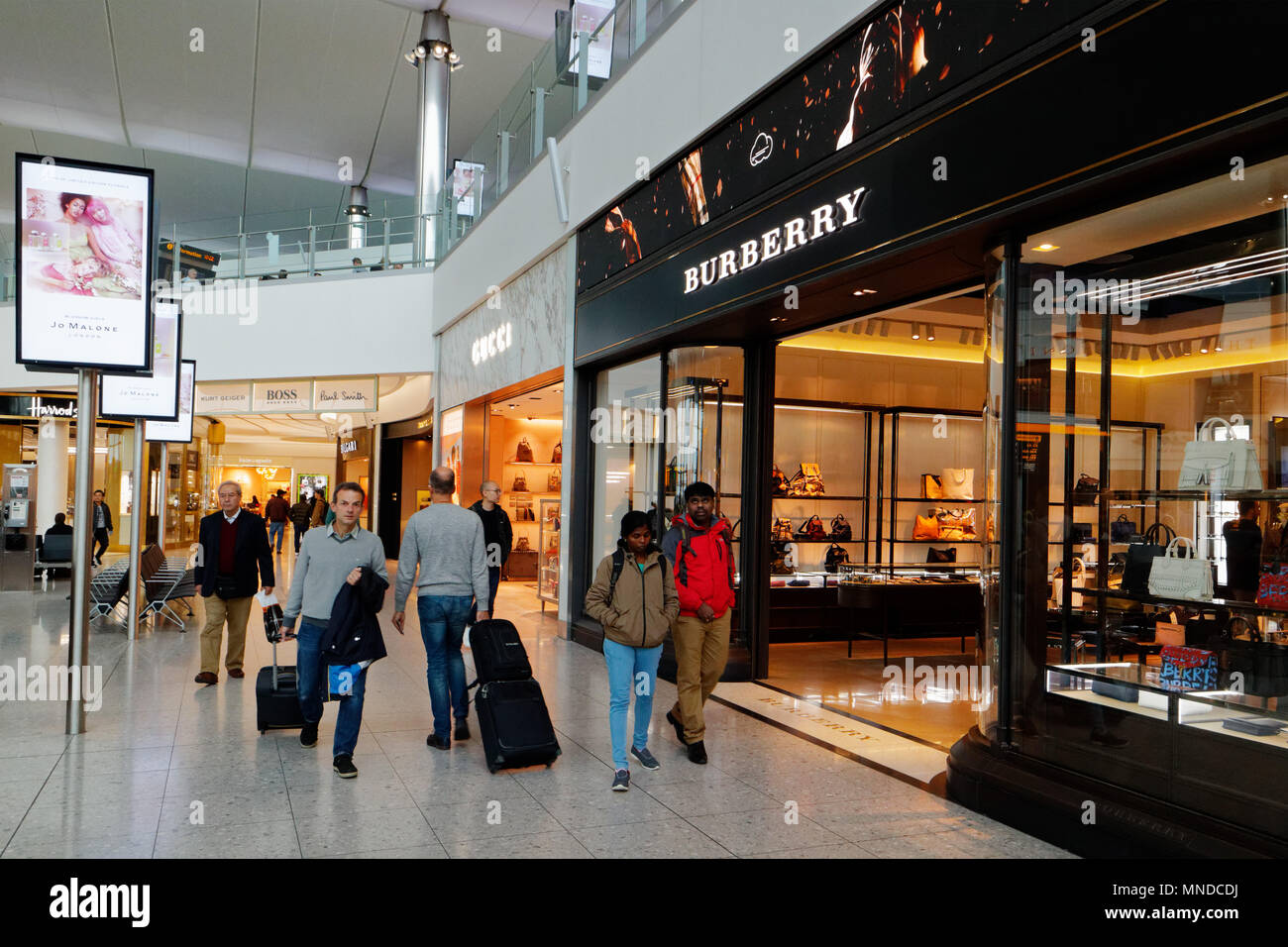 Burberry, Gucci and Boss duty free shops in London Heathrow Airport Terminal 2 Stock Photo