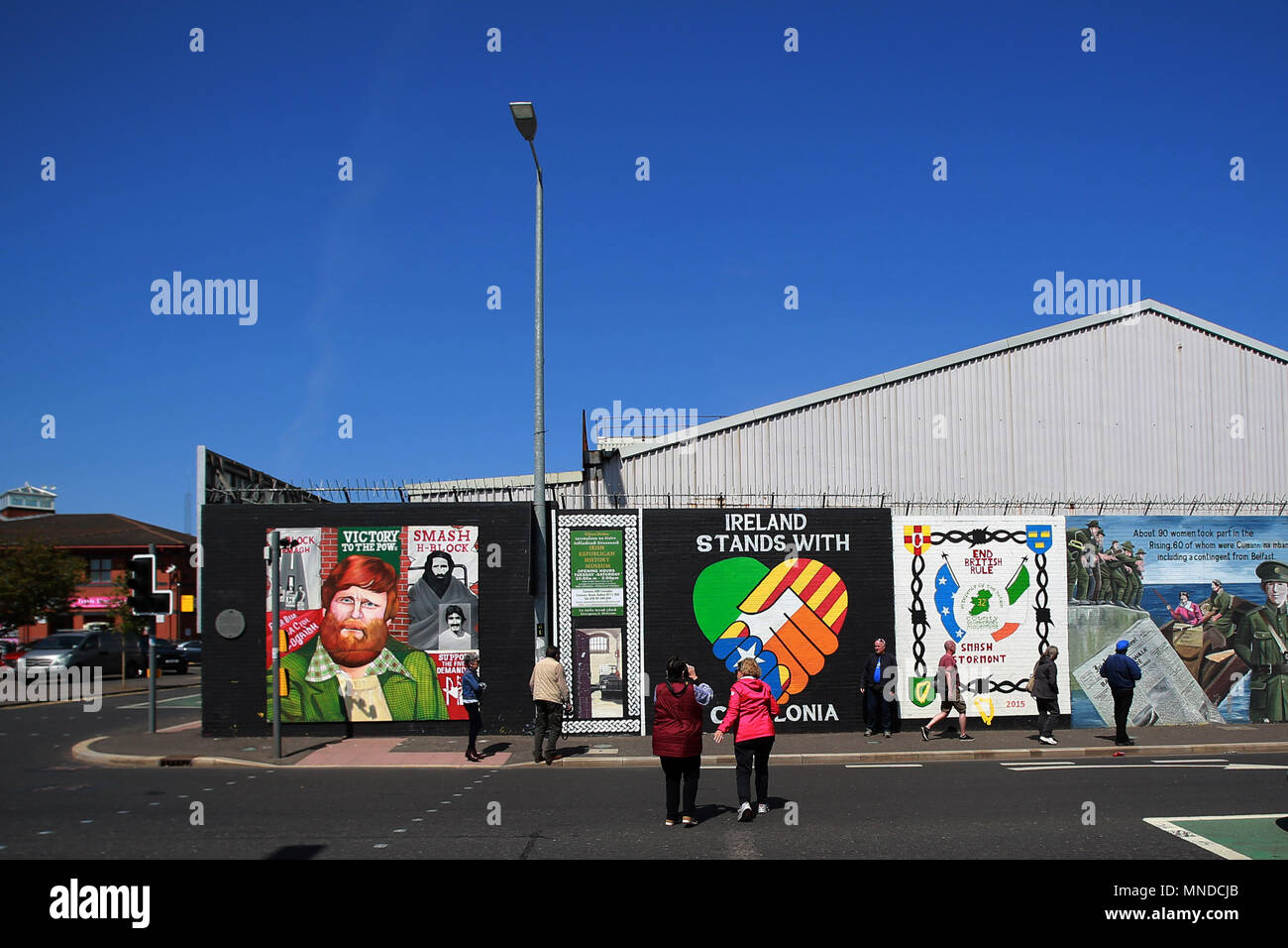 Tourist visit the Falls Road, west Belfast, May 2018. The Falls Road (from Irish túath na bhFál, meaning 'territory of the enclosures) is the main road through west Belfast, Northern Ireland, running from Divis Street in Belfast city centre to Andersonstown in the suburbs. Its name is synonymous with the republican community in the city, whilst the neighbouring Shankill Road is predominantly loyalist, separated from the Falls Road by peace lines. The road is usually referred to as the Falls Road, rather than as Falls Road. It is known as the Faas Raa in Ulster-Scots.[ Photo/Paul McErlane Stock Photo