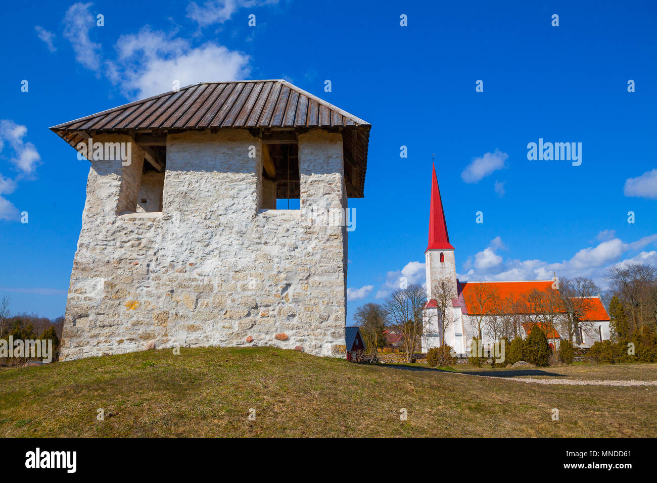 Medieval Lutheran church and bellfry in Kihelkonna, Saaremaa, Estonia. Spring sunny day. Landscape view. Stock Photo