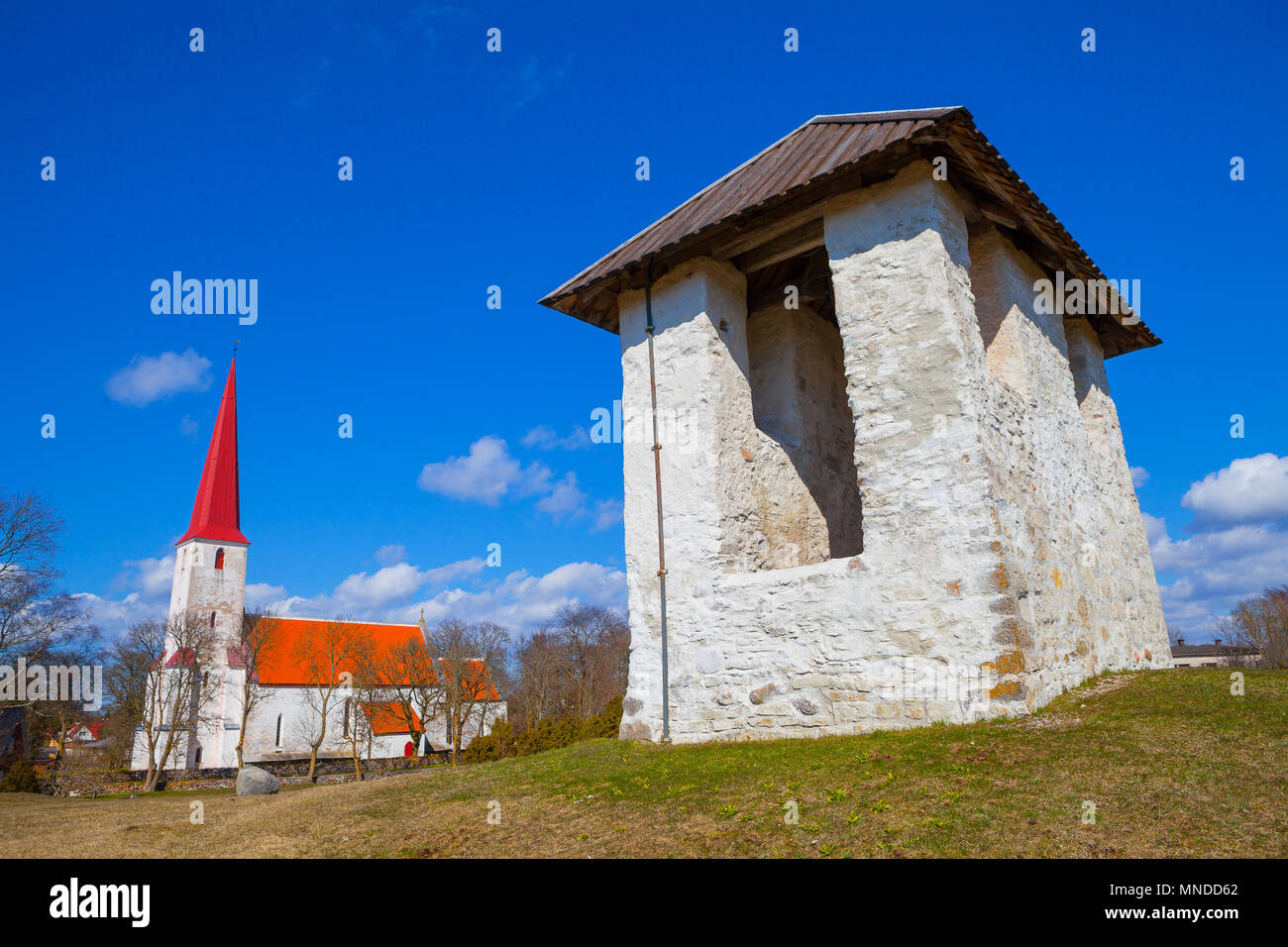 Medieval Lutheran church and bellfry in Kihelkonna, Saaremaa, Estonia. Spring sunny day. Landscape view. Stock Photo
