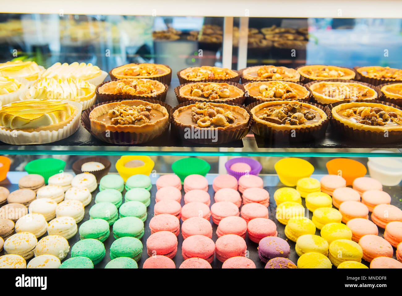 Assortment Of Colorful Macarons And Tarts For Sale In Shop Raws