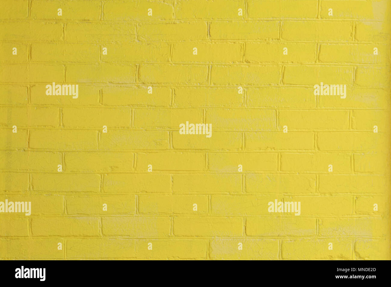 Yellow painted brick wall as a background or backdrop Stock Photo