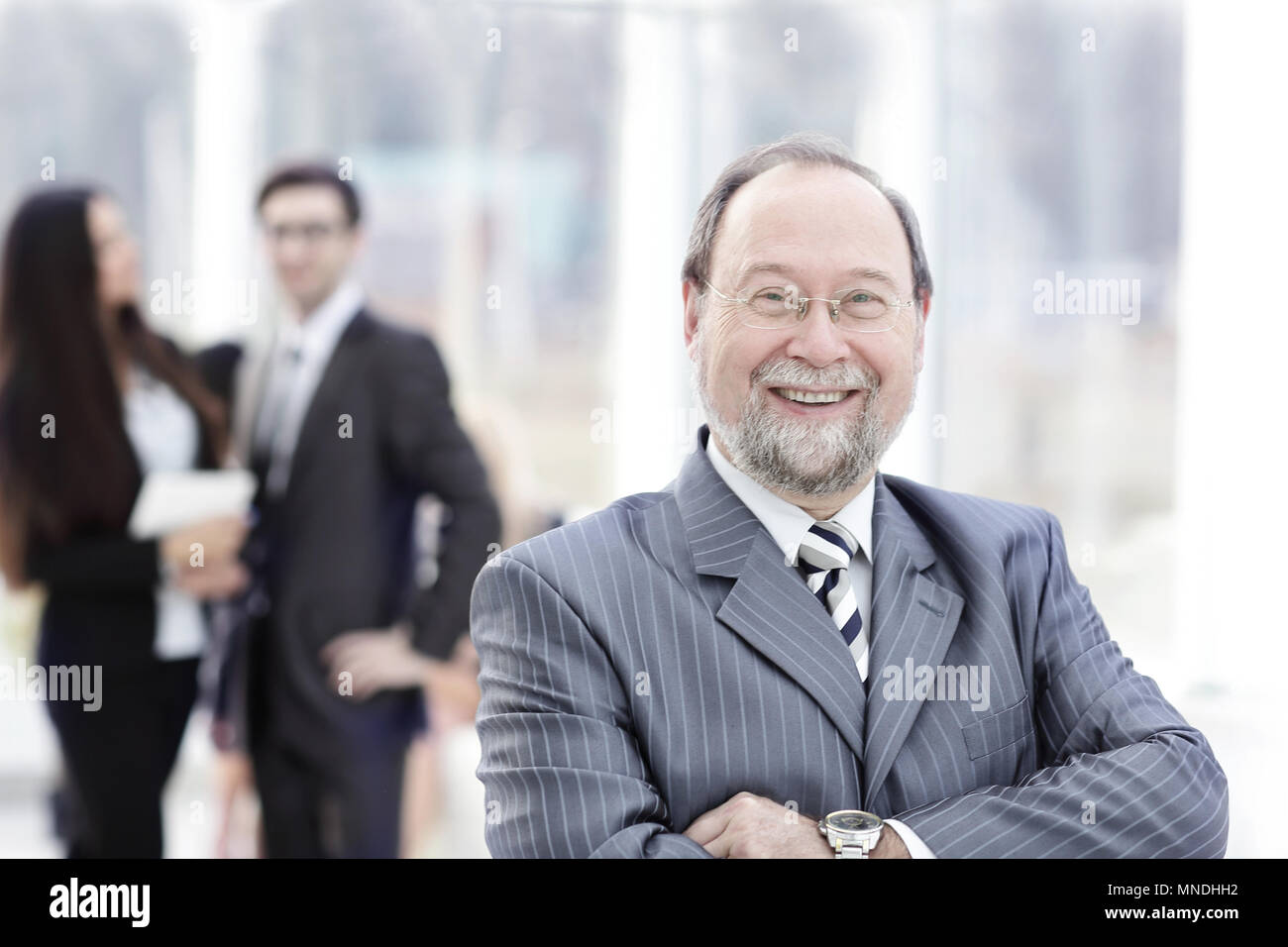 Business man at the office with a group behind him Stock Photo Alamy