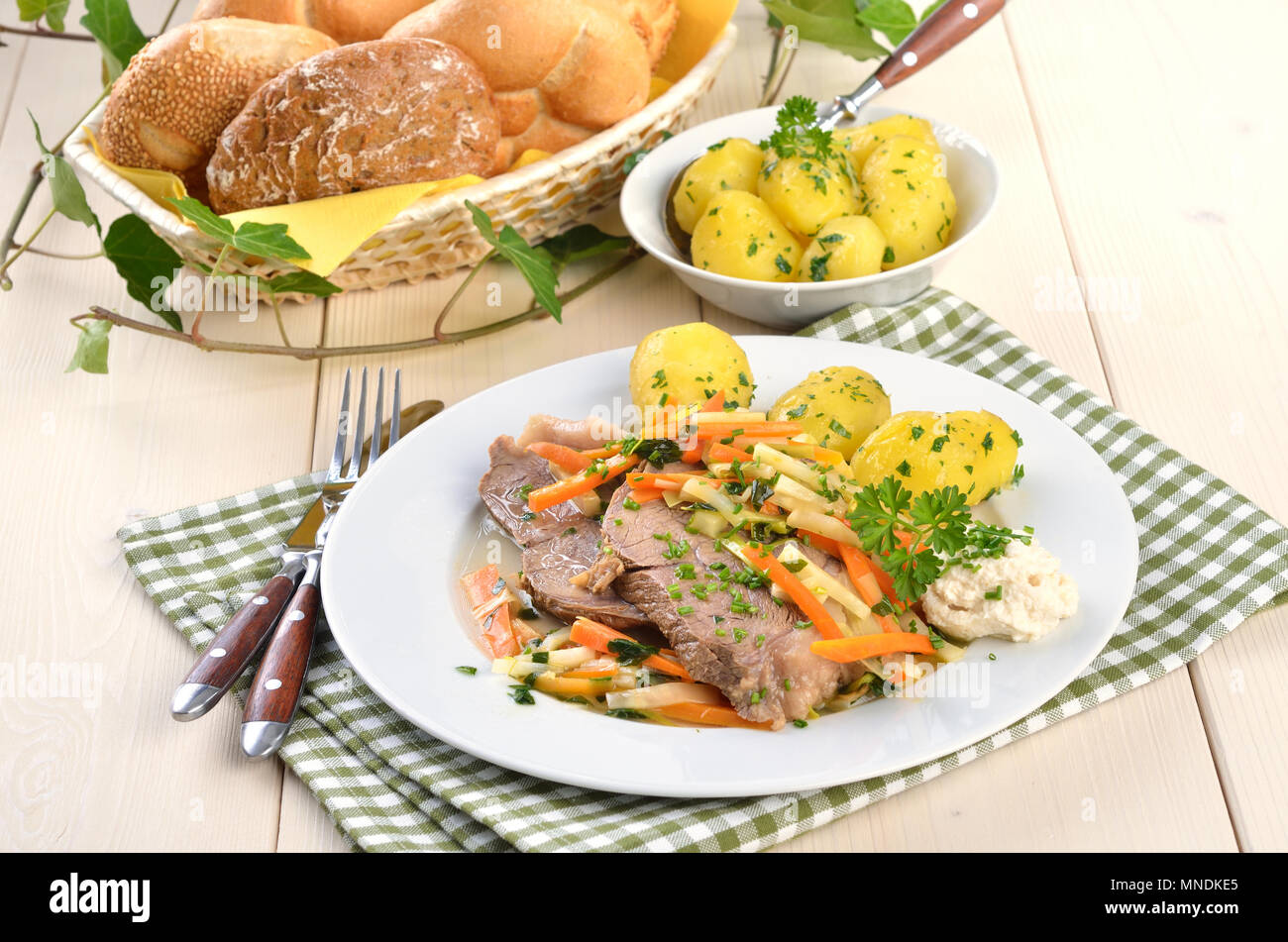 Prime boiled beef with root vegetables, butter potatoes and horse radish; (Viennese Tafelspitz) Stock Photo