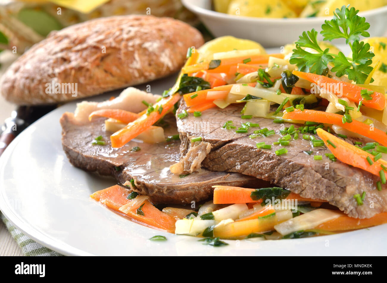 Prime boiled beef with root vegetables, butter potatoes and horse radish; (Viennese Tafelspitz) Stock Photo
