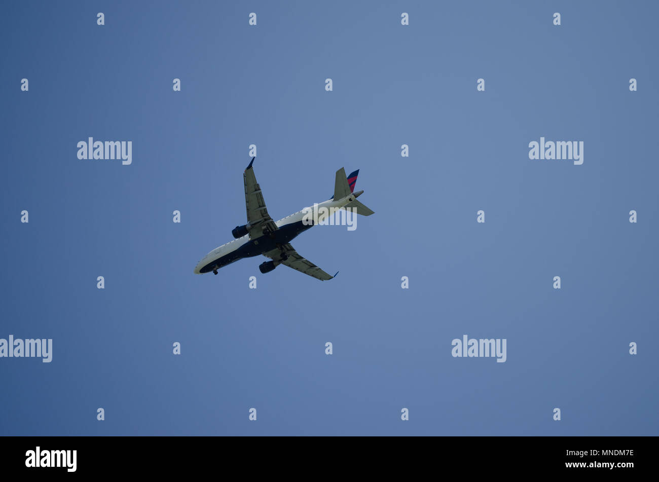 airplane flying with blue sky background Stock Photo - Alamy