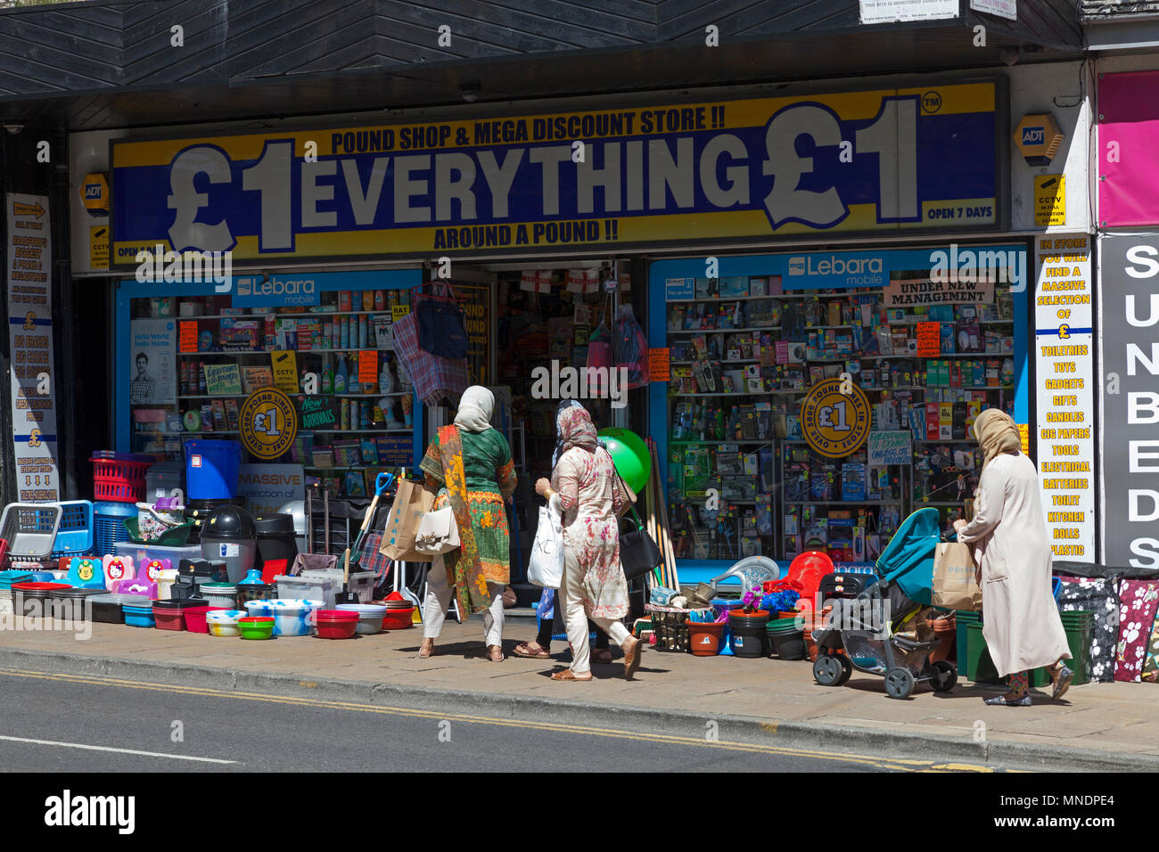 Group of Asian women at a pound shop, Bradford, West Yorkshire Stock Photo
