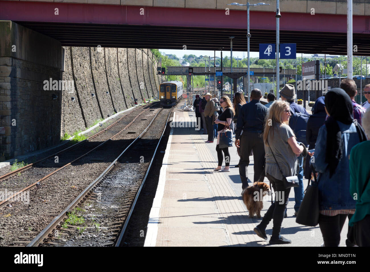 Passengers waiting for approaching Northern Rail train at Bradford Interchange station, Bradford, West Yorkshire Stock Photo