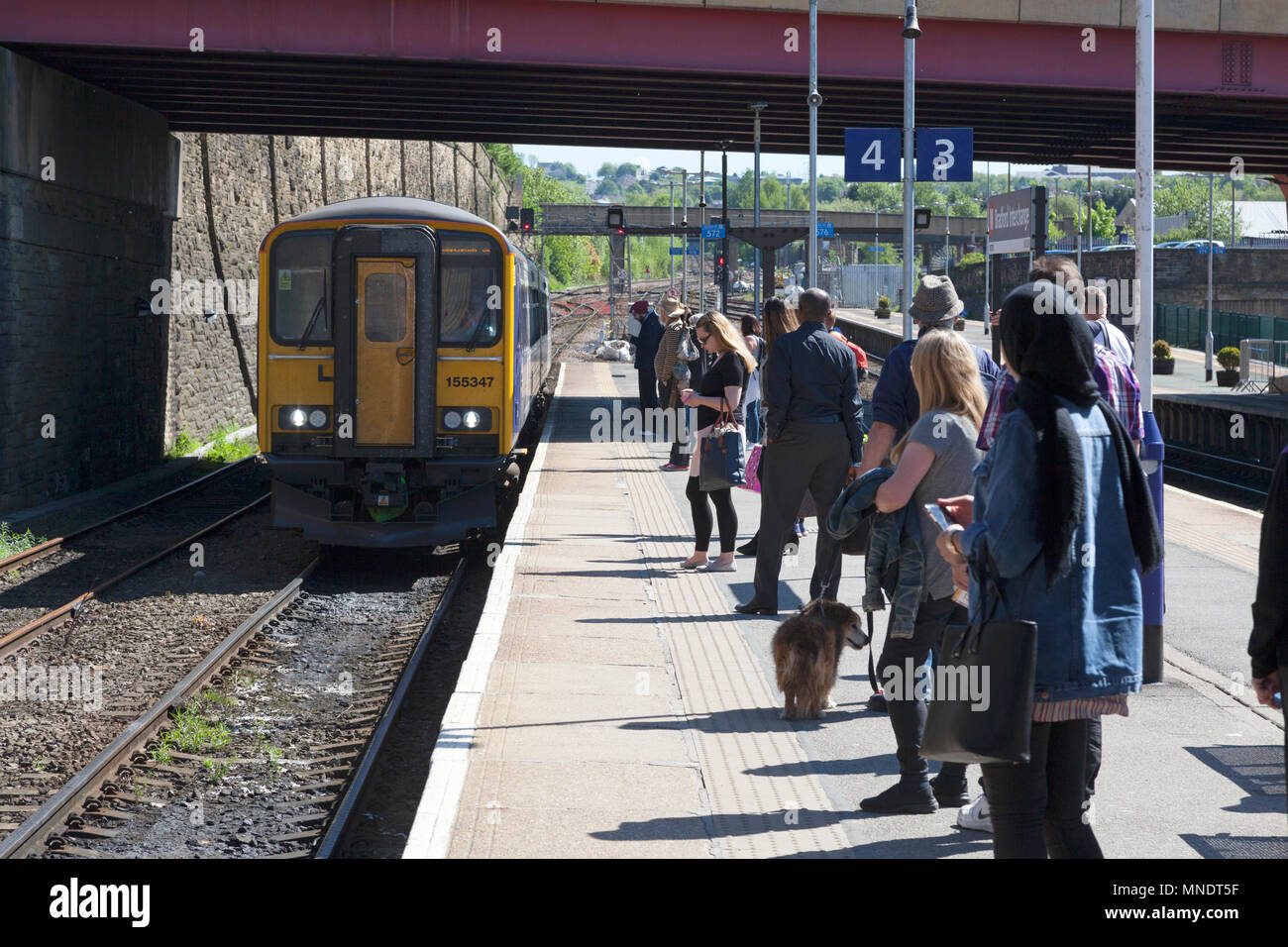 Passengers waiting for approaching Northern Rail train at Bradford Interchange station, Bradford, West Yorkshire Stock Photo