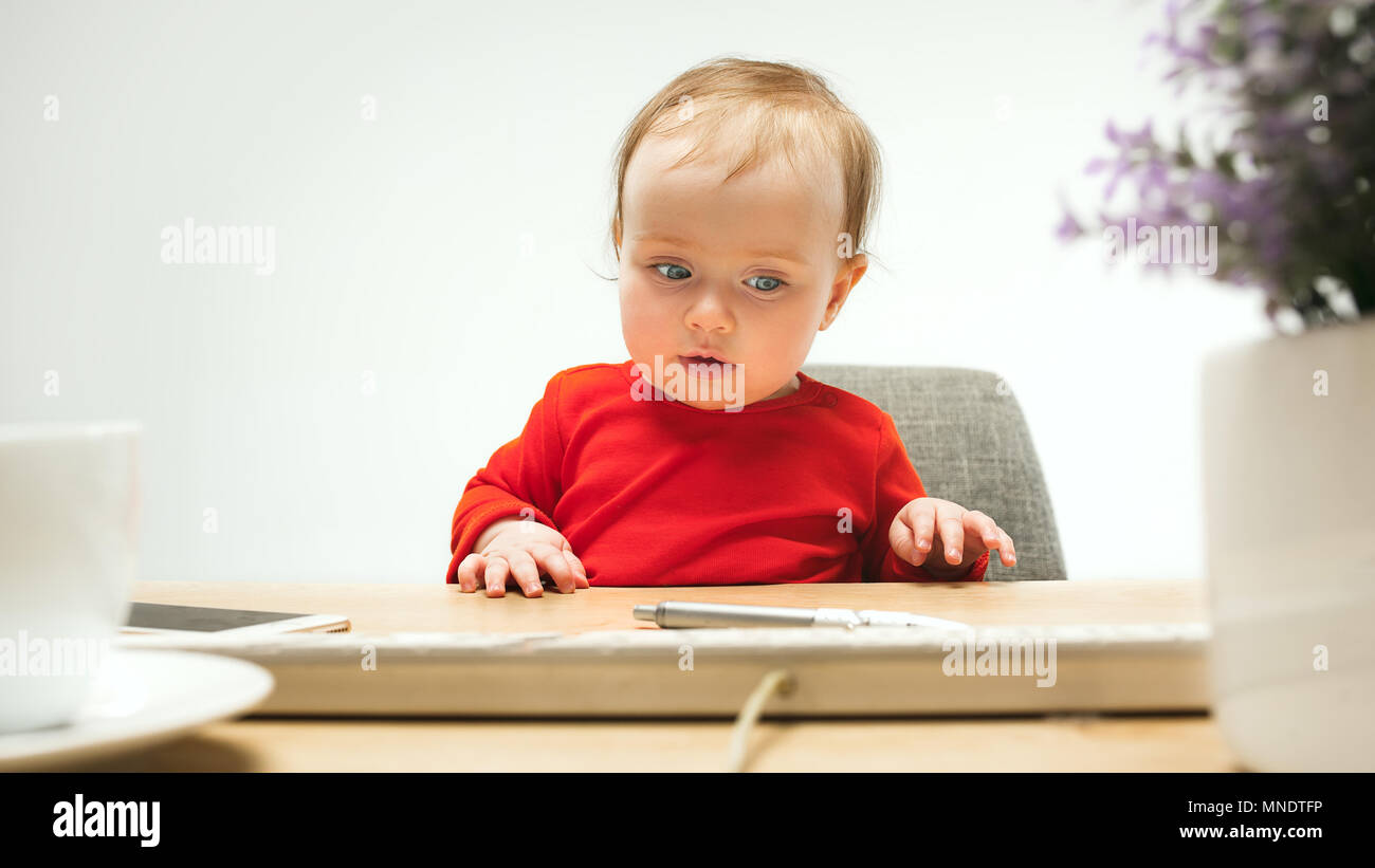 Happy child baby girl toddler sitting with keyboard of computer ...