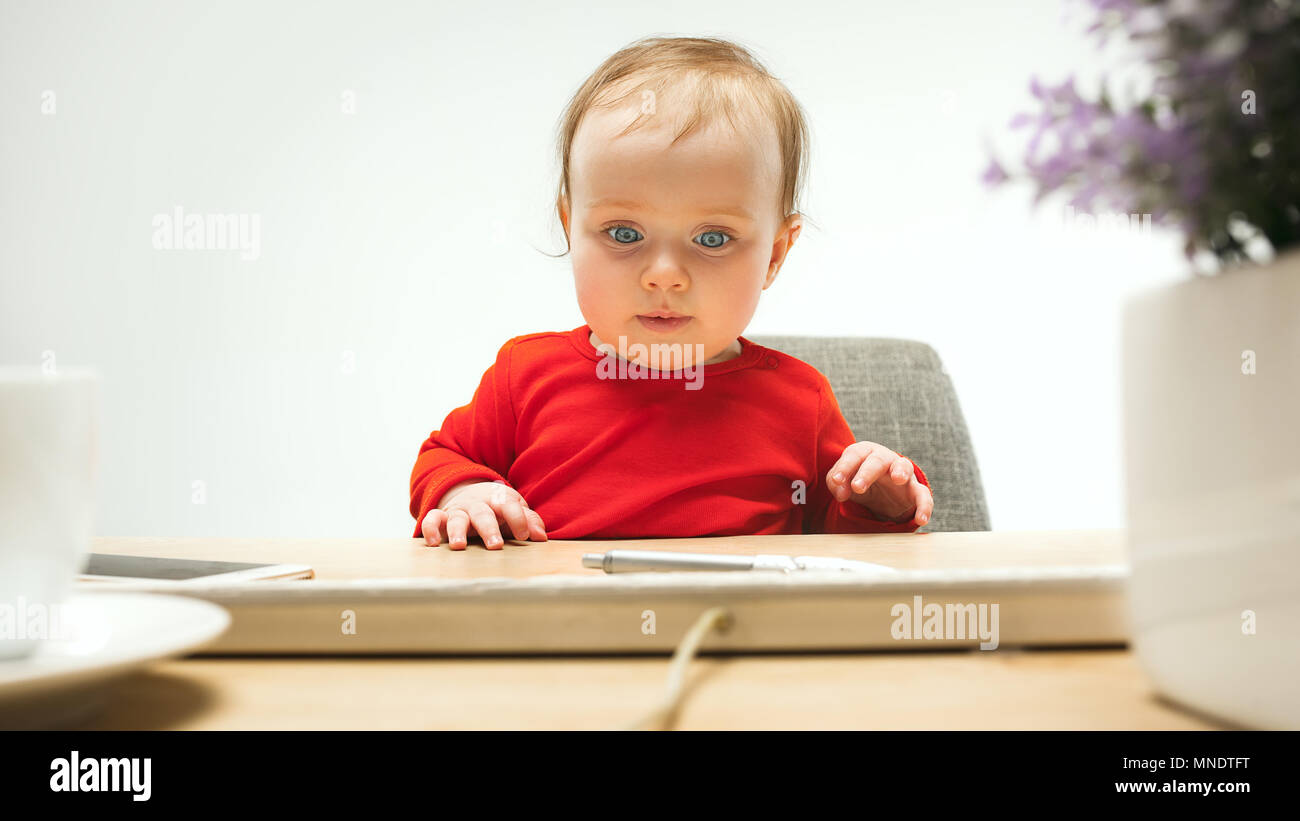 Happy child baby girl toddler sitting with keyboard of computer ...