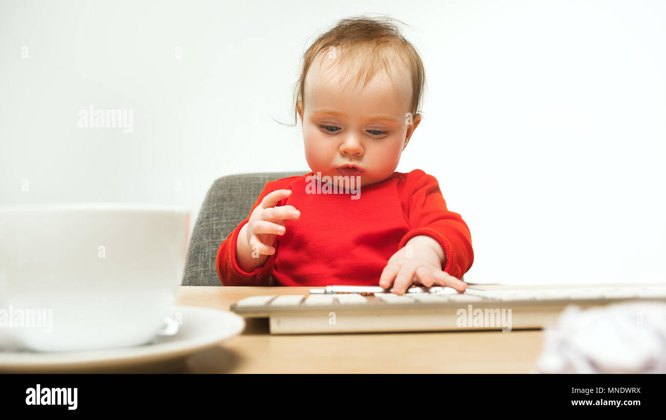 Happy child baby girl toddler sitting with keyboard of computer ...