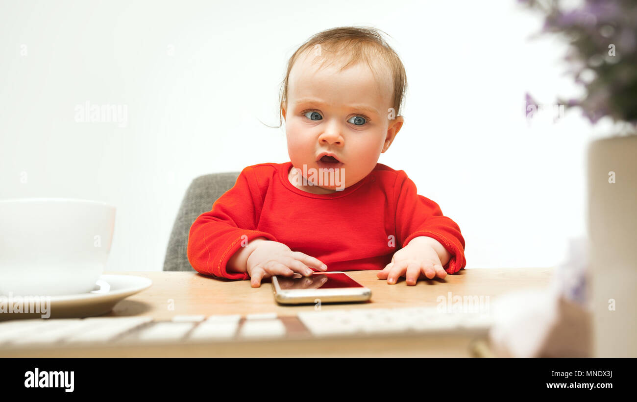 Happy child baby girl toddler sitting with keyboard of computer ...