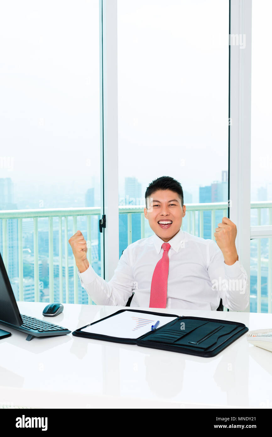 Asian broker trading in office making profit Stock Photo