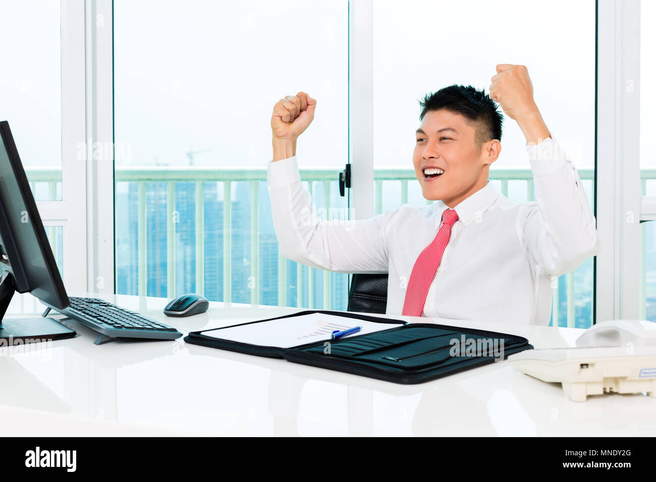 Asian broker trading in office making profit Stock Photo