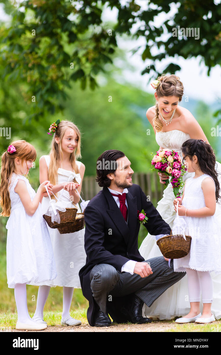 Bridal couple at wedding with bridesmaid children Stock Photo