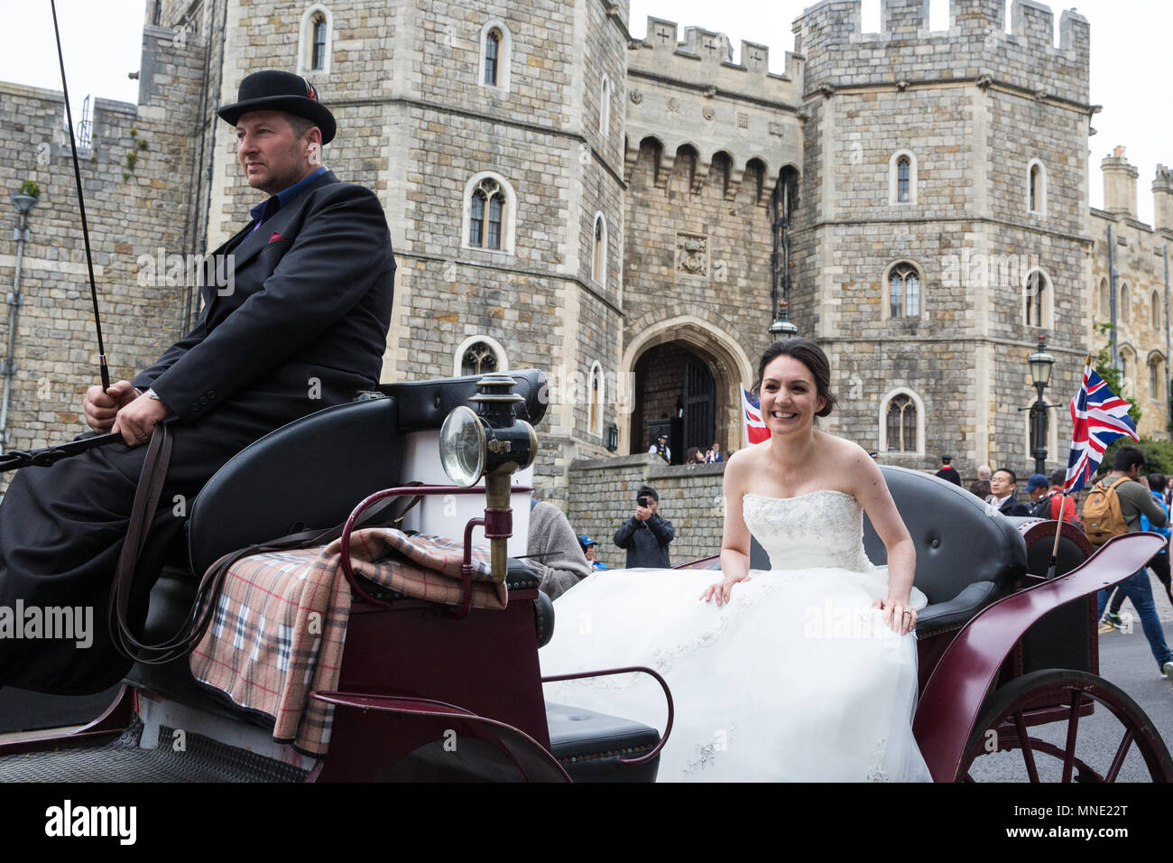 Windsor, UK. 16th May, 2018. Good Morning Britain presenter Laura Tobin, dressed as a bride, rides past Windsor Castle in a carriage in advance of the wedding between Prince Harry and Meghan Markle on Saturday. Credit: Mark Kerrison/Alamy Live News Stock Photo