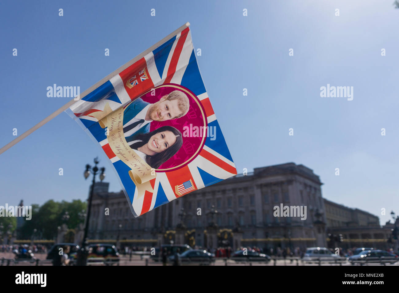 London, UK. 15th May 2018. Union jack flag with Prince Harry and Meghan Markle on is waved outside Buckingham palace before the Royal Wedding takes place in Windsor Credit: Ink Drop/Alamy Live News Stock Photo