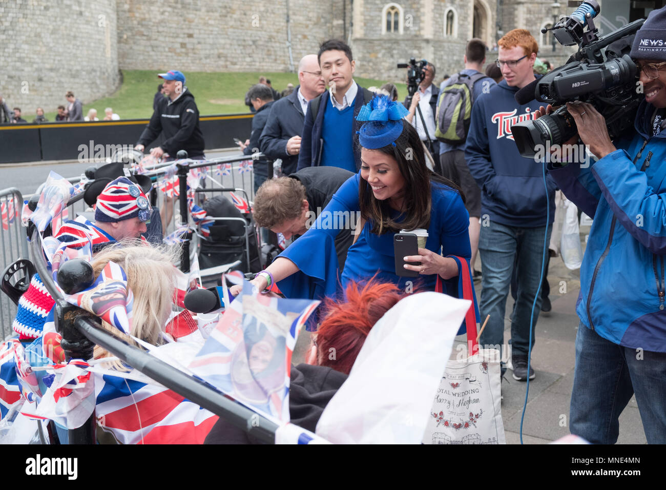 Royal Wedding preparations in Windsor town centre. Early Royal fans are staking claim to viewing spots and happy to be interviewed by multiple media personnel. Stock Photo