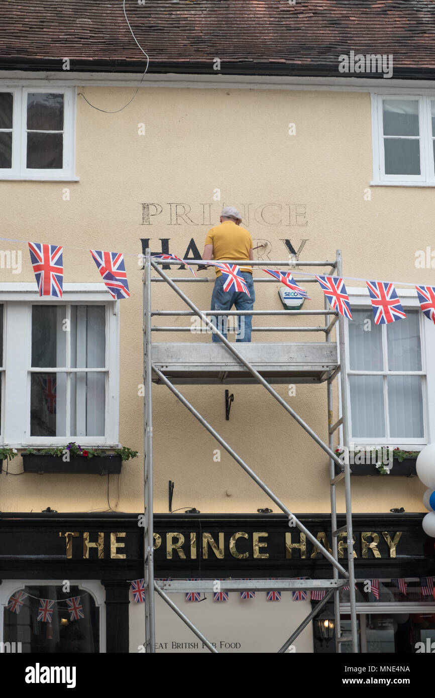 Royal Wedding preparations in Windsor town centre. A signwriter paints 'Prince Harry' on a pub which has changed its name from 'The Three Tuns' to 'The Prince Harry' Stock Photo