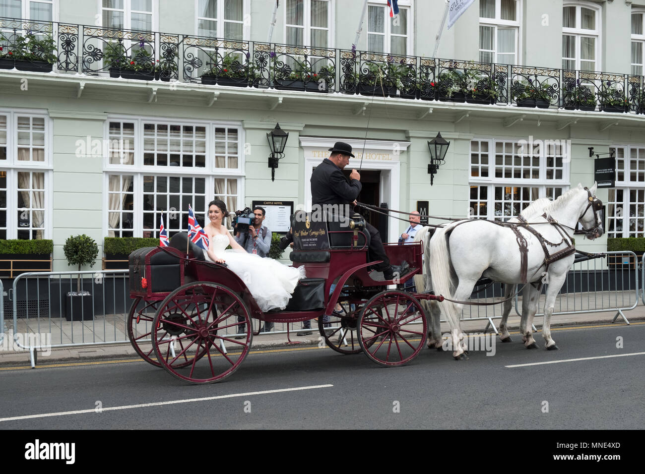 Royal Wedding preparations in Windsor town centre. A model bride is filmed riding in a carriage in the town. Stock Photo
