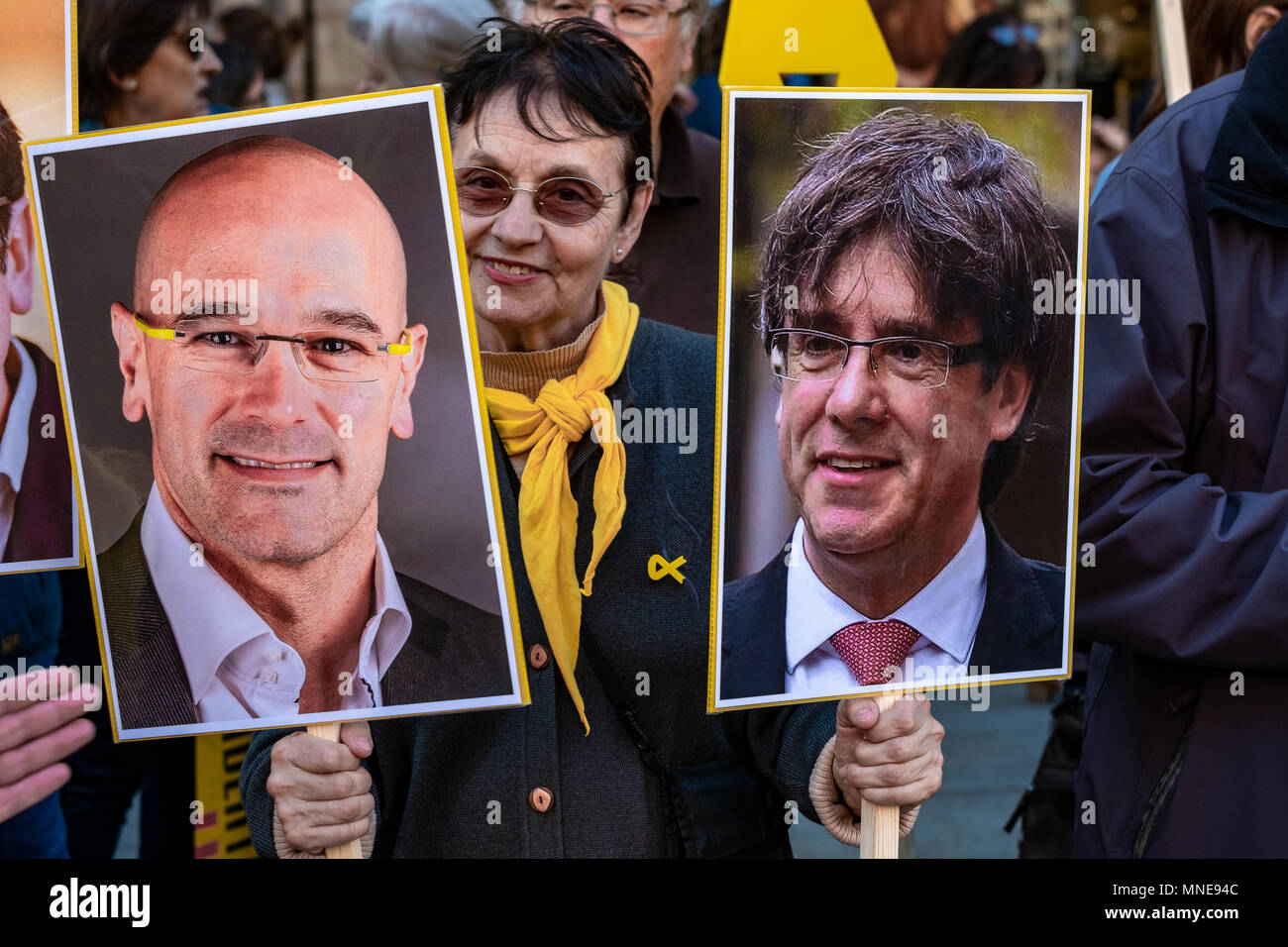 A female protester is seen among the portraits of former President Puigdemont and Councilor Raül Romeva. Act of protest to request the release of political prisoners Jordi Sànchez and Jordi Cuixart who have been in prison for seven months. It is the circumstance that it has been the first act in Catalonia of the president-elect of the Generalitat Qim Torra who has attended the rally. Stock Photo