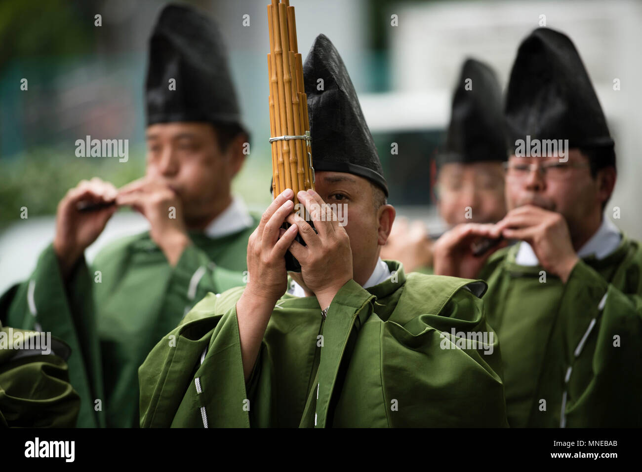 may 16 2018 a shinto priest plays a traditional wind instrument