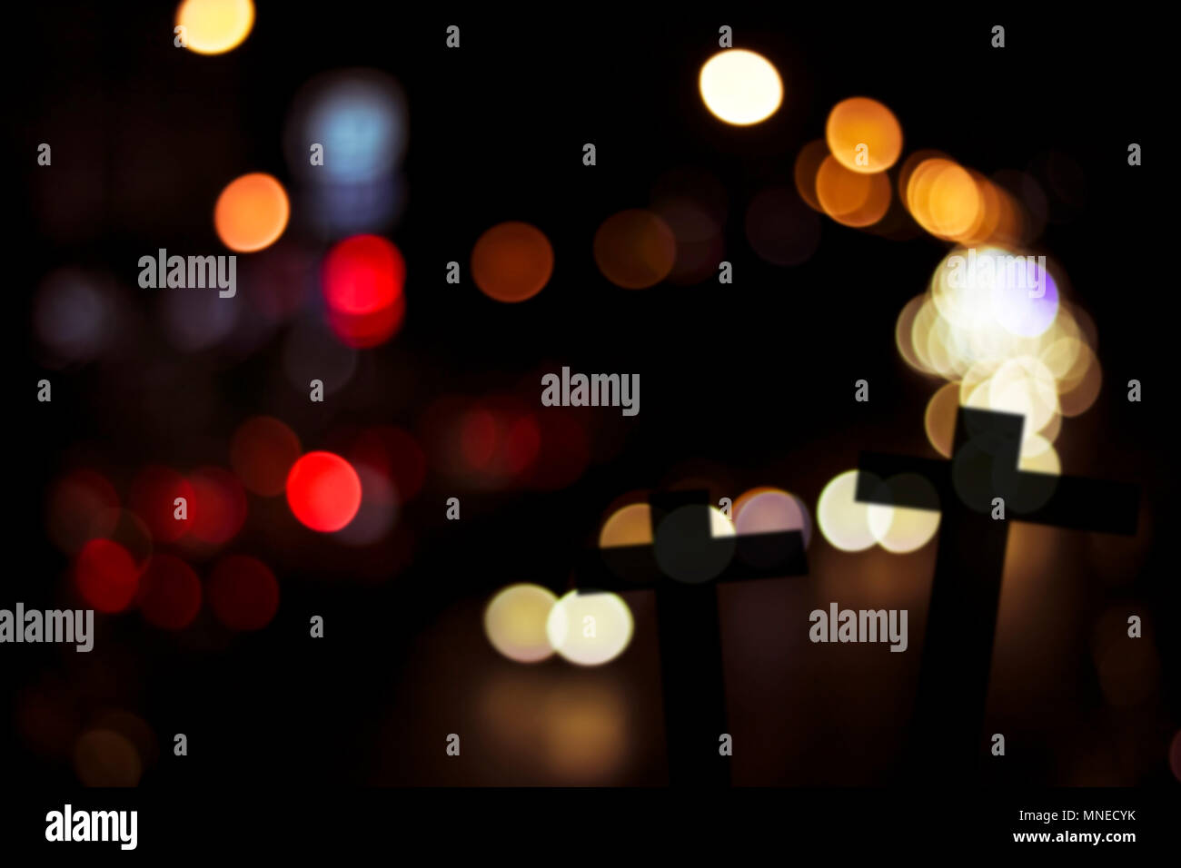 silhouette of cross wood with bokeh background, concept as halloween, belive and spiritual in Christian Stock Photo