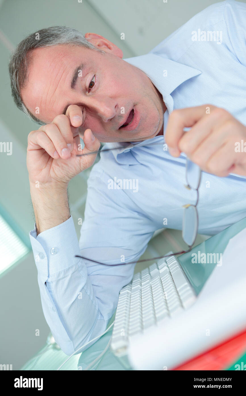 man rubbing his eyes Stock Photo