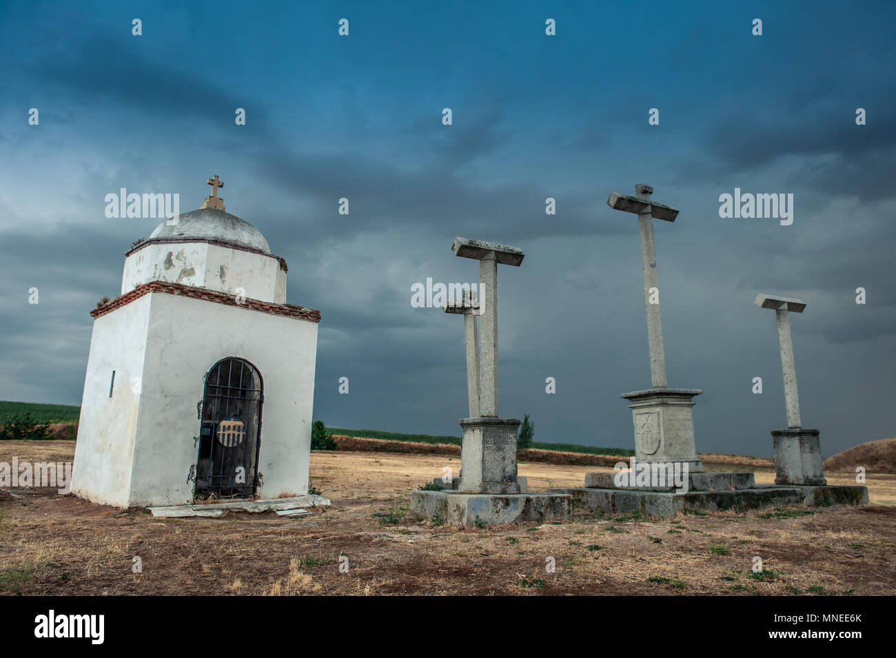 View at the small abandoned chapel and crosses next to it on the hill of Segovia city in Spain. Stormy sky above. Stock Photo