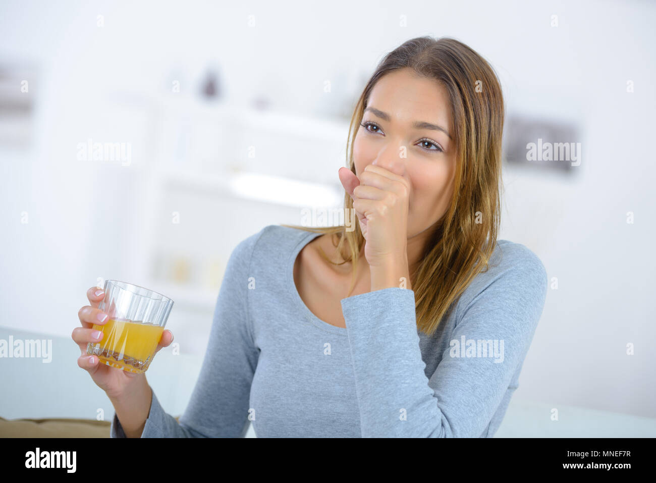 woman coughing drinking juice Stock Photo Alamy