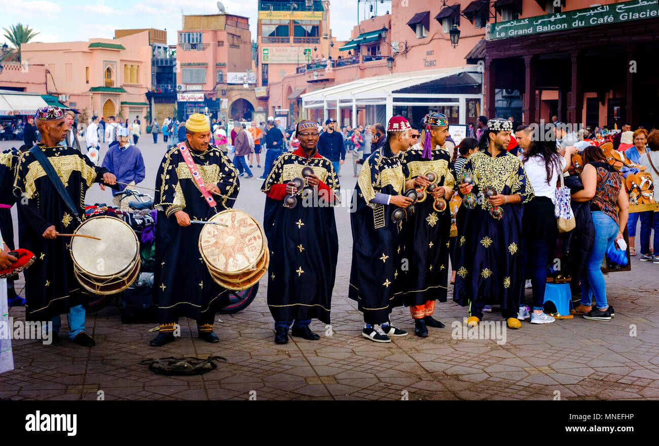 Percussionist in traditional costume entertaining tourists in the Jemaa El Fna, a world heritage site, Marrakech, Morocco Stock Photo