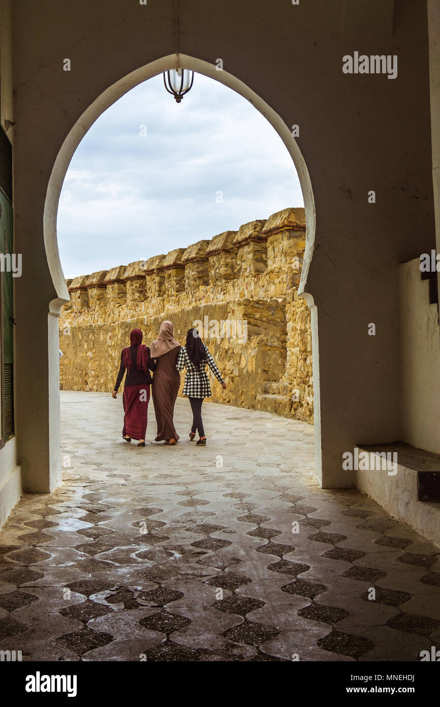Asilah, Morocco, May 23, 2017:  Three muslim women walking in the medina of Asilah, north of Morocco Stock Photo