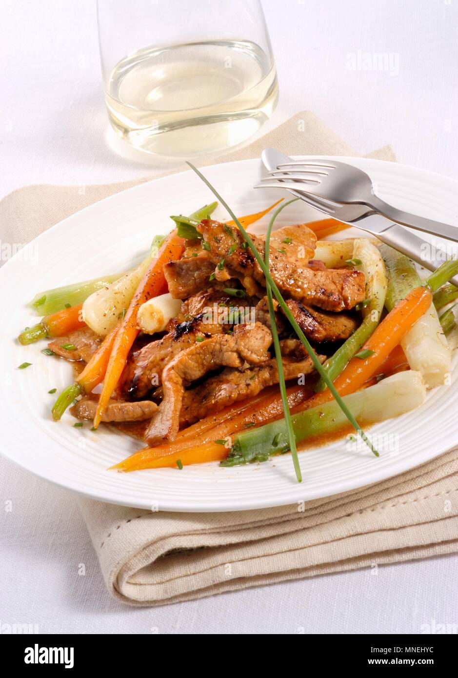 Veal strips with carrot and spring onions Stock Photo
