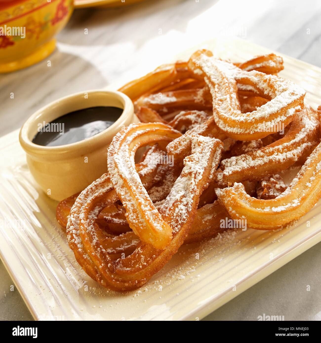 Churros with icing sugar and dark chocolate sauce (Mexico) Stock Photo