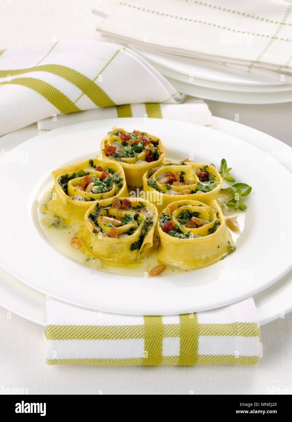 Gratinated pasta rolls with fresh herbs and pine nuts Stock Photo