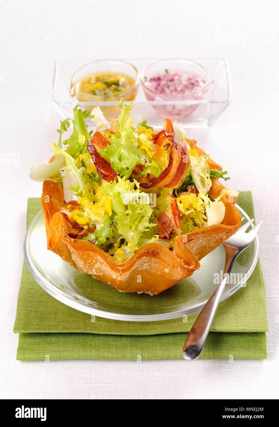 Frisee lettuce salad with bacon and egg Stock Photo