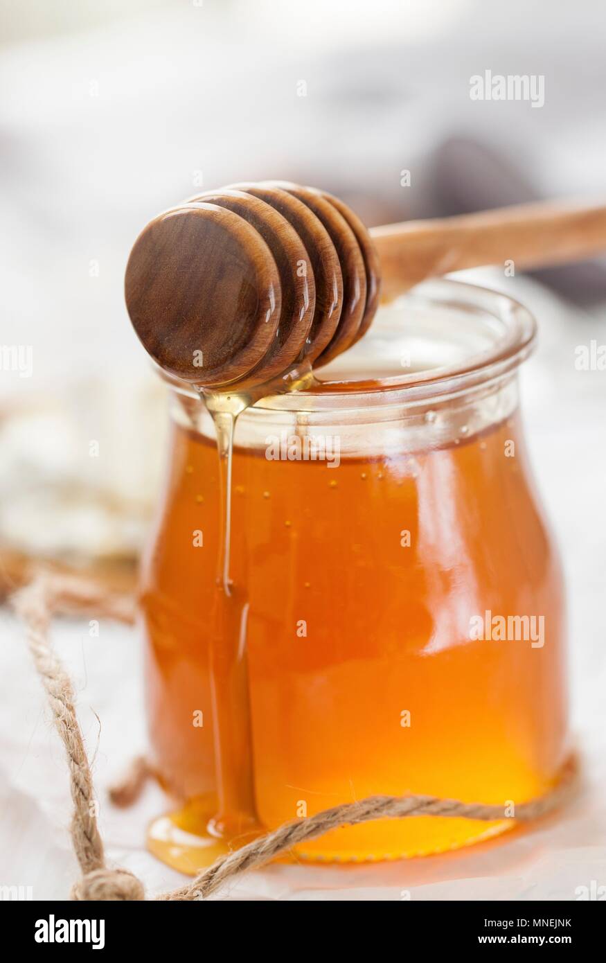 Honey with a honey dipper Stock Photo Alamy